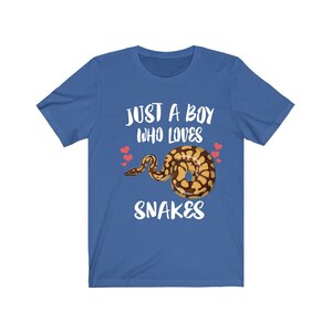 May include: A royal blue t-shirt with the text "Just a boy who loves snakes" in white. A cartoon snake with brown and yellow scales is in the centre of the shirt. Three small red hearts are above the snake.