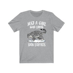 May include: Gray t-shirt with the text "Just a girl who loves snow leopards" and a cartoon image of a snow leopard walking on a patch of snow.