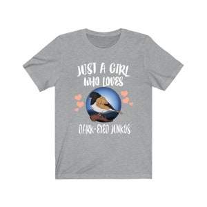 May include: Gray t-shirt with the text "Just a girl who loves dark-eyed juncos" and a cartoon image of a dark-eyed junco bird.