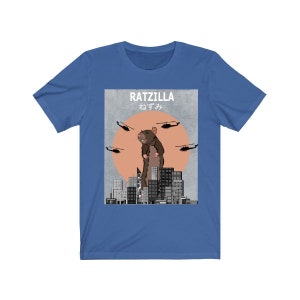 May include: A blue t-shirt with a graphic of a giant rat standing on a city skyline. The graphic says "RATZILLA" and "ねずみ" in Japanese.