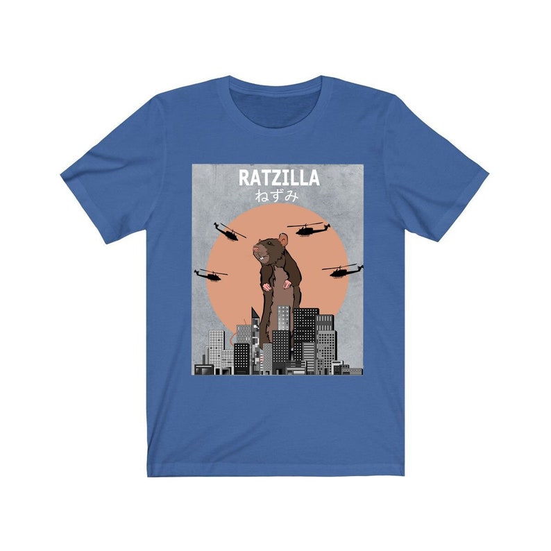 May include: A blue t-shirt with a graphic of a giant rat standing on a city skyline. The graphic says "RATZILLA" and "ねずみ" in Japanese.