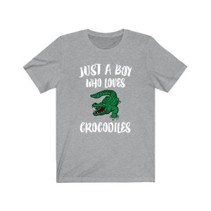 May include: Gray t-shirt with a white graphic that says "Just a boy who loves crocodiles" and a cartoon crocodile.