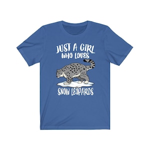 May include: A royal blue t-shirt with the text "Just a girl who loves snow leopards" and a cartoon image of a snow leopard on a snowy mountain.