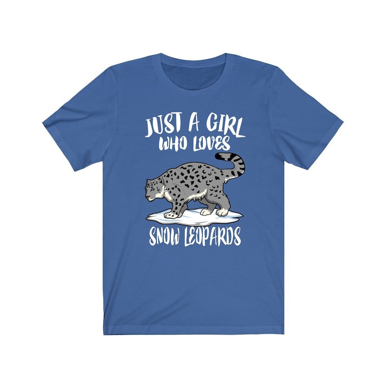 May include: A royal blue t-shirt with the text "Just a girl who loves snow leopards" and a cartoon image of a snow leopard on a snowy mountain.