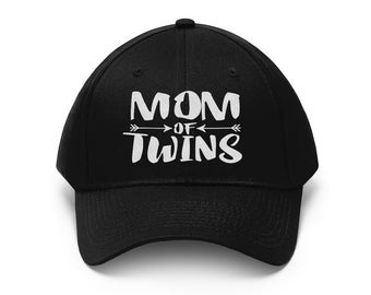 May include: Black baseball cap with white text that reads "MOM OF TWINS" with arrows pointing in opposite directions.