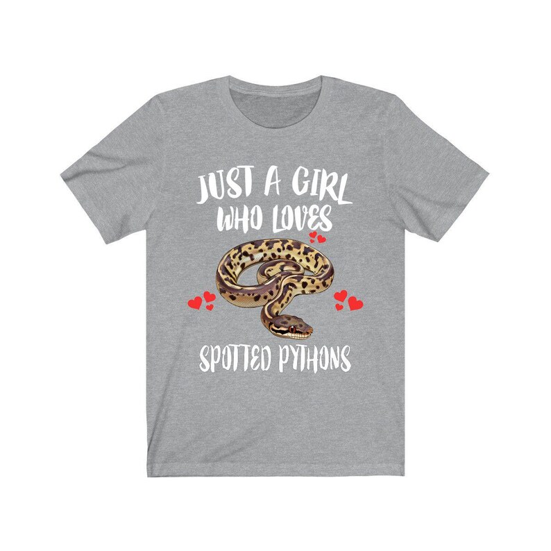 May include: A heather gray t-shirt with the text "JUST A GIRL WHO LOVES SPOTTED PYTHONS." The design features a spotted python illustration with red heart accents. The shirt is a casual wear item.