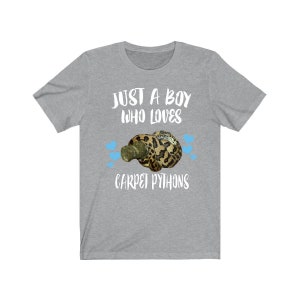 May include: Gray t-shirt with the text "Just a boy who loves carpet pythons" in white. A cartoon image of a carpet python is in the center of the shirt.