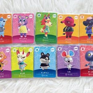 May include: Ten Animal Crossing character cards are displayed, each featuring a different anthropomorphic animal. The cards have colorful backgrounds and character names in Japanese. Each card has a unique number and character illustration.