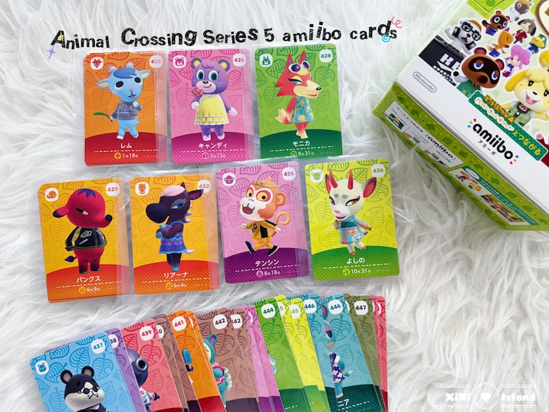 May include: A collection of Animal Crossing Series 5 amiibo cards featuring various characters, with a box of amiibo cards in the background. The cards have colorful designs and Japanese text. The text "Animal Crossing Series 5 amiibo cards" is at the top.