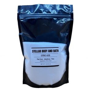 Peut inclure: Un sac refermable blanc rempli de poudre d'acide citrique blanche. Le sac porte une étiquette noire sur laquelle est inscrit "STELLAR BODY AND BATH CITRIC ACID Fine Grain - Anhydrous - Pure Ingredients: Citric Acid NET WT 1 LB (16 oz)"