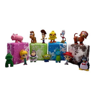 May include: A set of eight bath bombs featuring various Toy Story characters, including Woody, Buzz Lightyear, Jessie, and Rex. Each bath bomb is a different color and has a unique design.