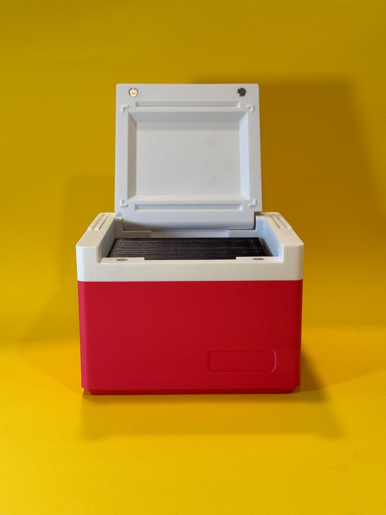 May include: A red and white cooler with the lid open. The cooler has a white interior and a black handle.