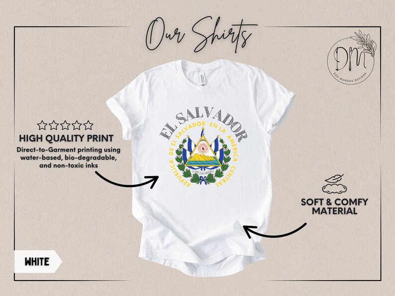 May include: A white short-sleeved t-shirt featuring the coat of arms of El Salvador printed in the center. The design includes the text EL SALVADOR and REPUBLICA DE EL SALVADOR EN LA AMERICA CENTRAL. The shirt is displayed with informational text.