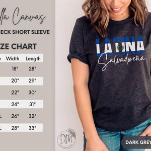 May include: A dark grey heather crewneck short sleeve t-shirt featuring the word LATINA with the blue and white flag of El Salvador as the fill, and the word Salvadore&ntilde;a in white script below. A size chart with width and length in inches is visible.