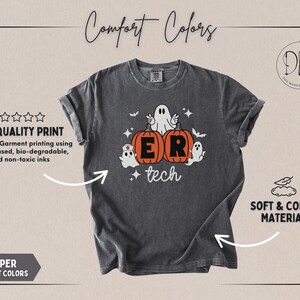May include: A charcoal gray short-sleeve t-shirt featuring a graphic of two orange pumpkins with the letters E and R, surrounded by three white ghosts, one wearing a nurse cap, with the word tech written below in white script lettering.