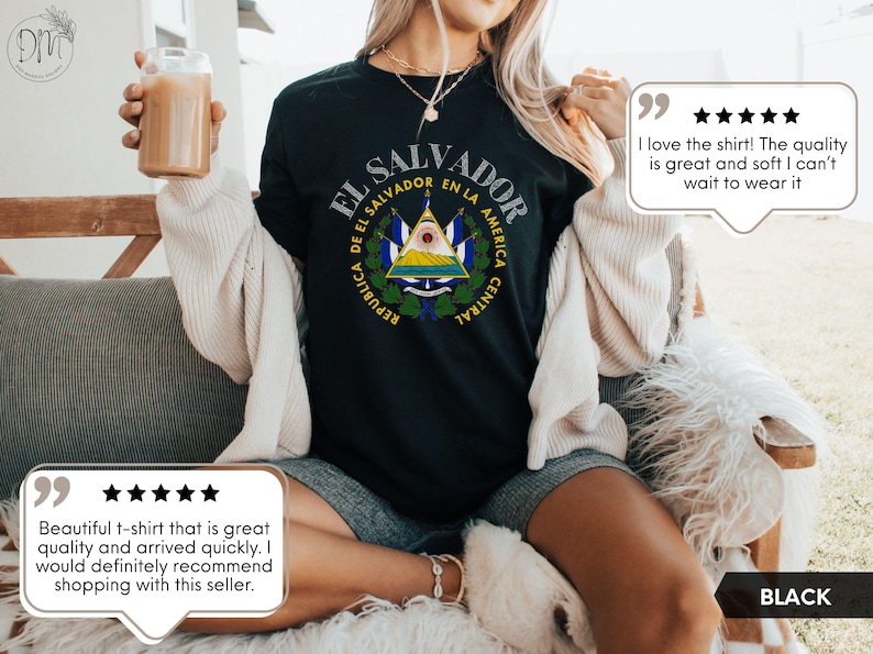 May include: A black short-sleeved t-shirt featuring the coat of arms of El Salvador printed in the center. The design includes the text REPUBLICA DE EL SALVADOR EN LA AMERICA CENTRAL in a circular arrangement around the national emblem.