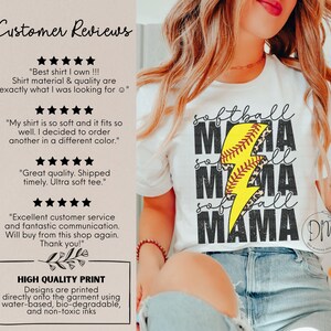 a woman wearing a baseball shirt with a lightning bolt on it