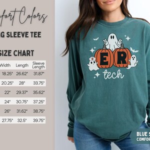 May include: A blue spruce long sleeve t-shirt featuring a graphic of two orange pumpkins with the letters E and R, surrounded by three white ghosts, one wearing a nurse cap, and the text tech. A size chart with measurements in inches is visible.