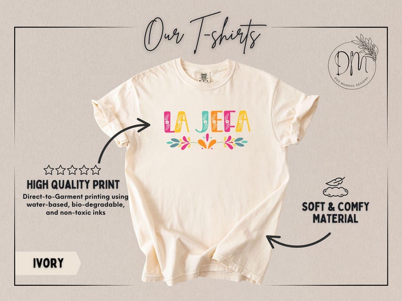 May include: Ivory t-shirt featuring the text "LA JEFA" in vibrant colours and floral designs. The shirt is described as soft and comfy, with high-quality, water-based, and non-toxic print.