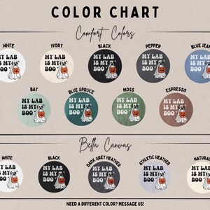 May include: A colour chart displaying various t-shirt colour options labelled Comfort Colors and Bella Canvas. Each circular swatch features a graphic of a dog dressed as a ghost holding a pumpkin with the text MY LAB IS MY BOO in black or white.