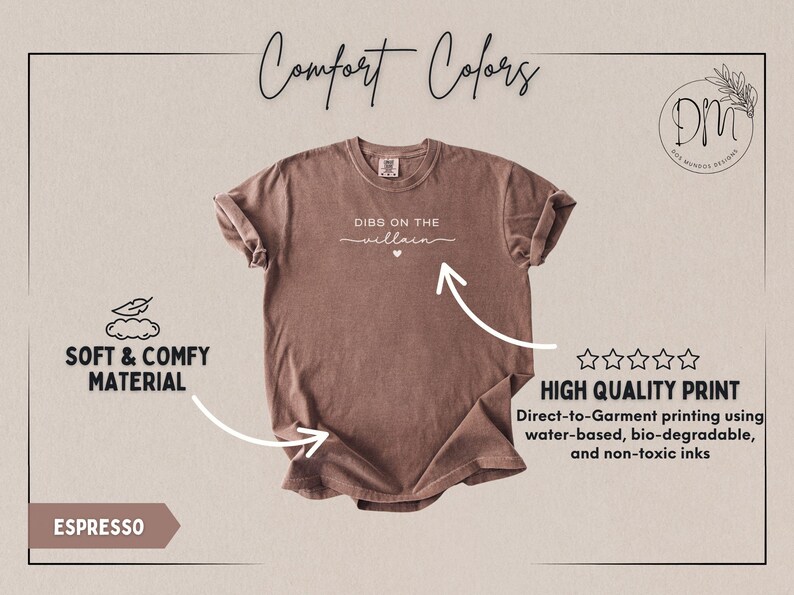 May include: Espresso-colored t-shirt with the text "DIBS ON THE villain" in white script. The shirt features a crew neck and rolled sleeves. The image also highlights the soft and comfy material and high-quality print.