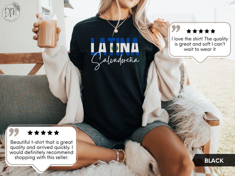 May include: A black short-sleeved t-shirt featuring the text LATINA in bold blue and white letters, with the flag of El Salvador integrated into the design. Below the word LATINA, the word Salvadore&ntilde;a is printed in a white cursive script font.