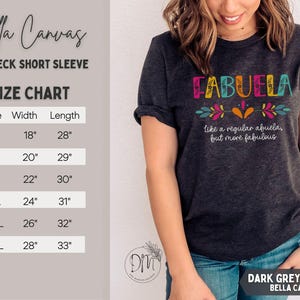 May include: Dark grey heather Bella Canvas crewneck short sleeve t-shirt. The shirt features the word "FABUELA" in colorful letters with floral accents. Below the word is the phrase "like a regular abuela, but more fabulous". The size chart shows the width and length in inches.