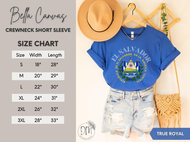 May include: A true royal blue short-sleeve crewneck t-shirt featuring the El Salvador coat of arms graphic. The image includes a size chart with width and length measurements in inches for sizes S through 3XL, a tan hat, and denim shorts.
