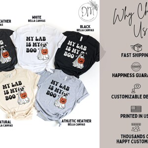 May include: Five short-sleeved t-shirts in dark grey heather, white, black, natural, and athletic heather. Each shirt features a graphic of a dog wearing a ghost costume and holding an orange pumpkin bucket with the text MY LAB IS MY BOO.