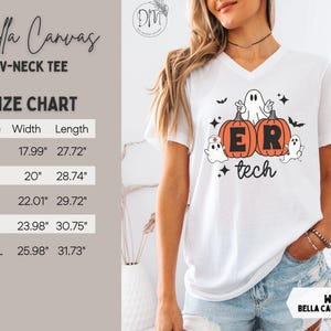 May include: A white V-neck t-shirt featuring a graphic of two orange pumpkins with the letters E and R, surrounded by three ghosts and bats. The text reads ER tech. A size chart is visible with widths and lengths in inches from 17.99 to 31.73.