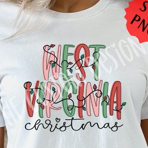 May include: White t-shirt with a festive design that says "West Virginia Christmas" in colorful letters with red and green lights.