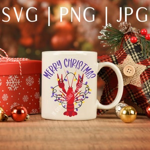 May include: White ceramic mug with a red crawfish and purple Christmas lights, the text "Merry Christmas" is written in purple on the mug.