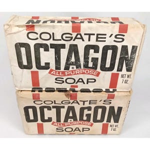 May include: Two vintage Colgate's Octagon All Purpose Soap boxes. The boxes are white with black text and red accents. The text includes "COLGATE'S OCTAGON ALL PURPOSE SOAP" and "NET WT. 7 OZ."