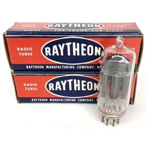 May include: Two vintage Raytheon radio tube boxes with a clear glass tube in front. The boxes are red and blue with the Raytheon logo and text that reads "Radio Tubes" and "Television Tubes". The glass tube has several internal components and metal pins.