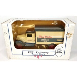 May include: A die-cast metal 1931 Delivery Truck Bank in its original packaging. The truck is cream-colored with a black top and red wheels. The side of the truck features the True Value Hardware logo and text.