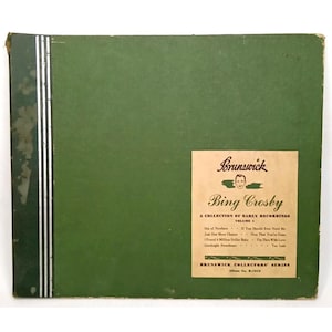 May include: A vintage green album cover featuring a label with the name "Bing Crosby" and the Brunswick logo. The album is titled "A Collection of Early Recordings Volume 1." The cover has a vertical silver stripe on the left side.