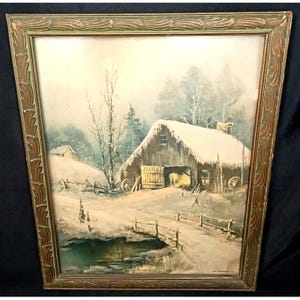 May include: A framed winter landscape painting. The artwork depicts a snow-covered barn with a bridge and a small pond. The frame is a decorative gold and green color. The scene is a watercolor painting.