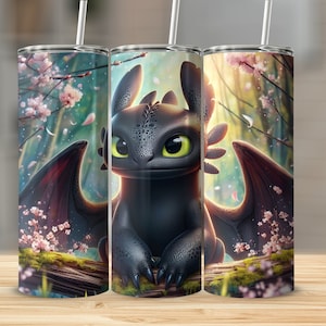 May include: A stainless steel tumbler featuring a black dragon with large green eyes, set against a backdrop of a forest with pink cherry blossoms. The dragon is perched on a log, with its wings spread. A white straw is inserted in the lid.