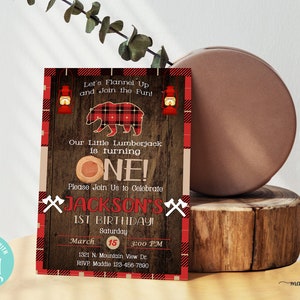 May include: A red and black plaid lumberjack themed first birthday party invitation with a cartoon bear, a woodgrain background, and the text "Let's Flannel Up and Join the Fun! Our Little Lumberjack is turning ONE! Please Join Us to Celebrate JACKSON'S 1st BIRTHDAY! Saturday, March 15, 3:00 PM, 1321 N. Mountain View Dr., RSVP Maddie 123-456-7890".