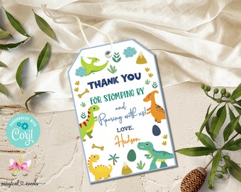 May include: A blue and white thank you tag with a dinosaur theme. The tag features a green, orange, and yellow dinosaur with the text "Thank you for stomping by and roaring with us! Love, Hudson".