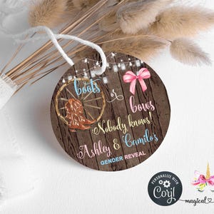May include: A round wooden tag with the text "boots or bows Nobody knows! Ashley & Camilo's GENDER REVEAL". The tag features a cowboy boot, a pink bow, and string lights. A white ribbon and dried flowers are in the background.