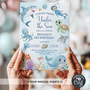 May include: An invitation for a third birthday party with an "Under the Sea" theme. The design features cartoon illustrations of sea creatures like a shark, octopus, and whale. The invitation includes the date, time, and location.