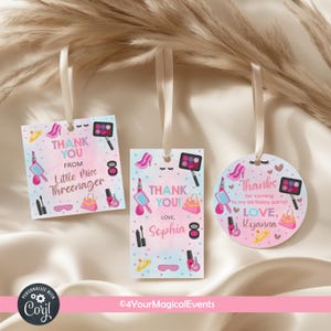 May include: Three gift tags with white ribbons, featuring a makeup theme. The tags have pink and blue backgrounds with illustrations of makeup items, high heels, and purses. Text includes "Thank You" and personalized names.
