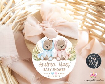 May include: Round baby shower favor tag with two teddy bears wearing blue and pink hooded outfits. The tag has a brown background with the text "Andrea Vines' Baby Shower" and the date "12.18.2023".