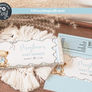 May include: Baby shower favours with a teddy bear illustration. The favours are light blue and white with the text "Meghan's BABY SHOWER JANUARY 28 3-7 PM". The favours are on a white macrame coaster.