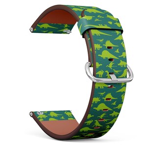 May include: A green and brown leather watch strap with a dinosaur pattern. The strap has a silver buckle.