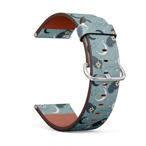 May include: A brown leather watch band with a blue and white pattern of sloths and stars. The band has a silver buckle.