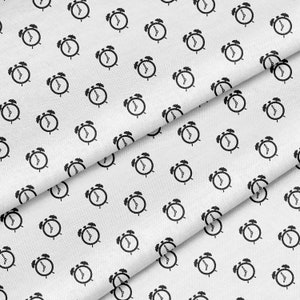 May include: White fabric with a repeating pattern of black alarm clocks.