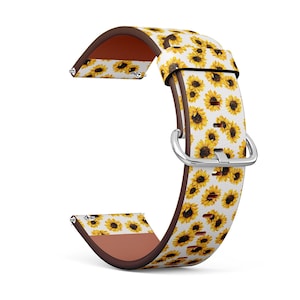 May include: A white and yellow watch band with a sunflower pattern. The band is made of leather and has a brown underside. The band has a silver buckle.
