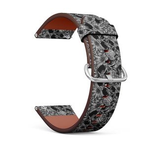 May include: A brown leather watch band with a black and white skull and floral pattern.